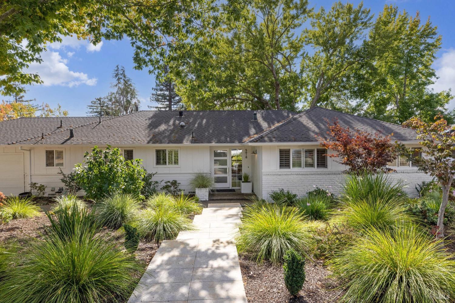 a front view of a house with a garden