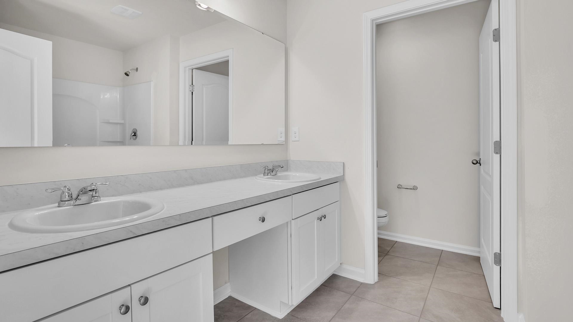 123 Redbud Road Palm Coast, FL 32137 - Photo 13 of 29 a bathroom with a sink and a mirror