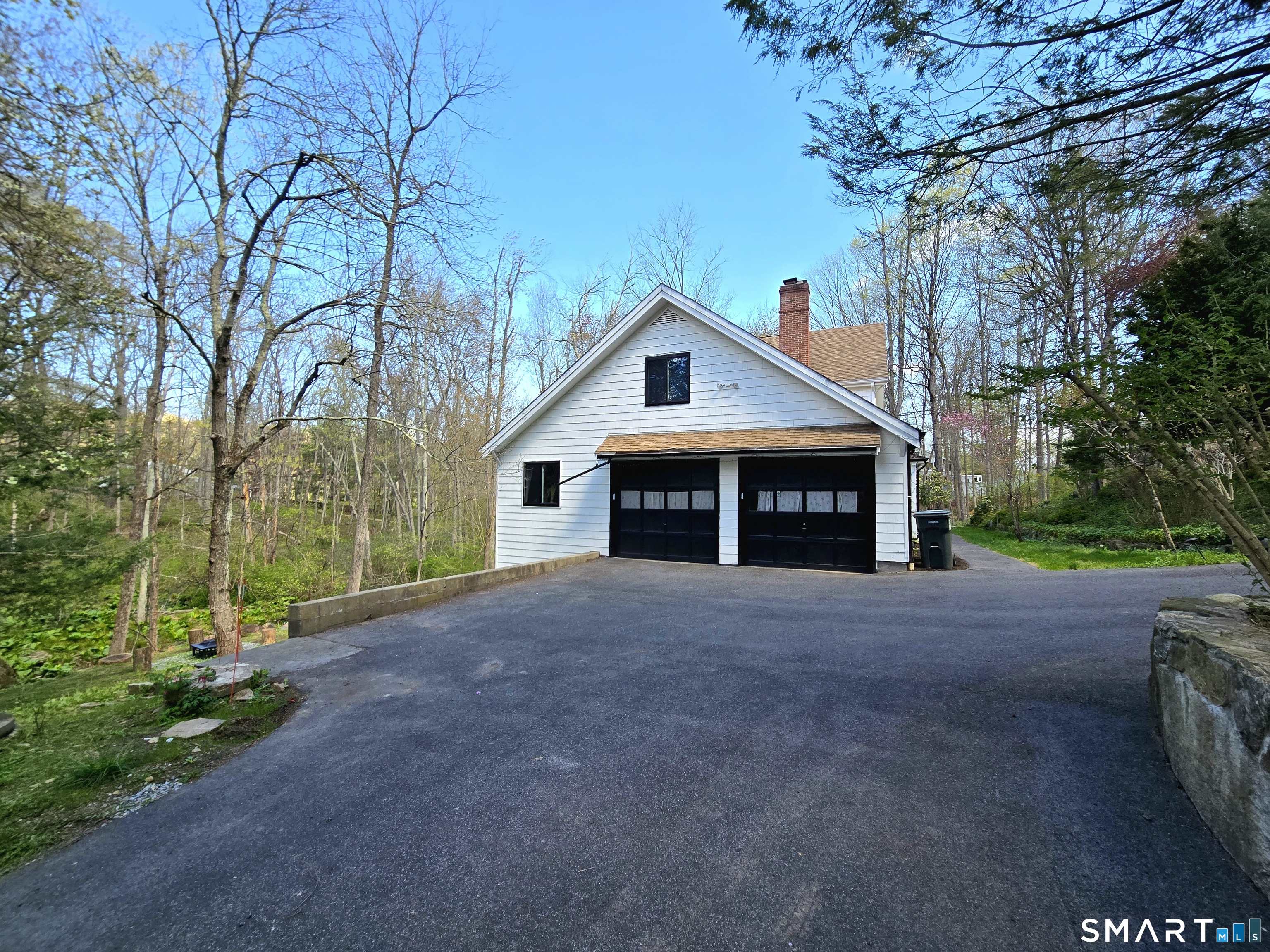 299 Redding Road Redding, CT 06896 - Photo 33 of 38 a front view of a house with a garden and trees