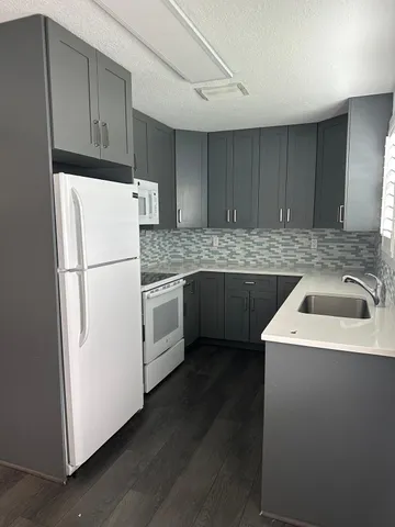 a white refrigerator freezer sitting inside of a kitchen