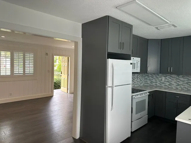 a white refrigerator freezer sitting inside of a kitchen