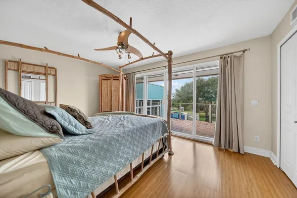 a bedroom with a bed and a view of balcony