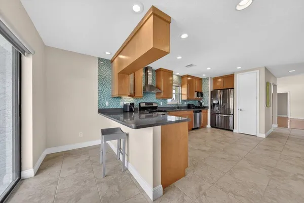a view of game room with window and wooden floor
