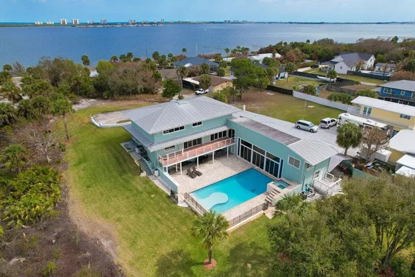 an aerial view of residential building with outdoor space and lake view