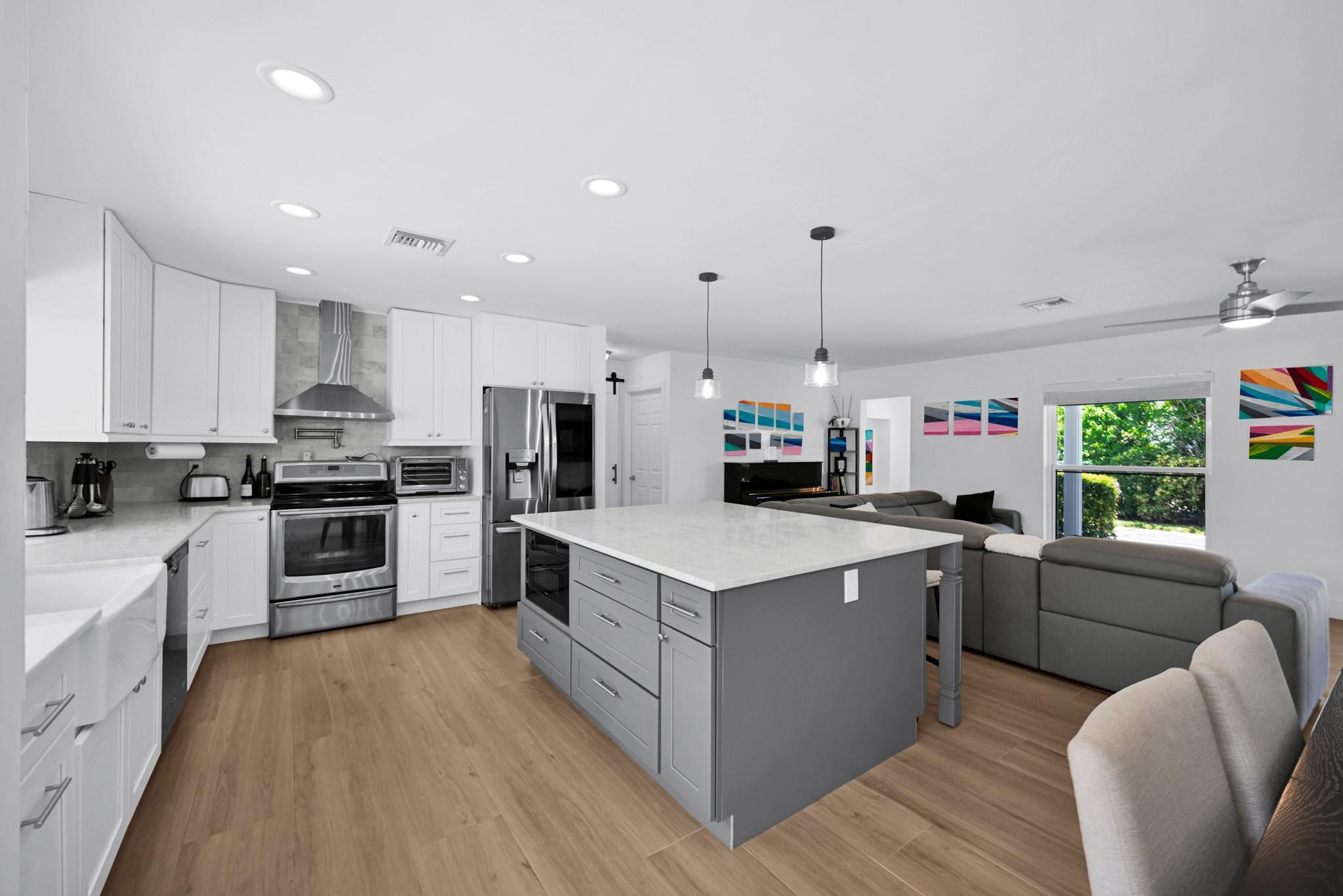 252 Southwest 14th Place Boca Raton, FL 33432 - Photo 15 of 49 a kitchen with white cabinets and stainless steel appliances