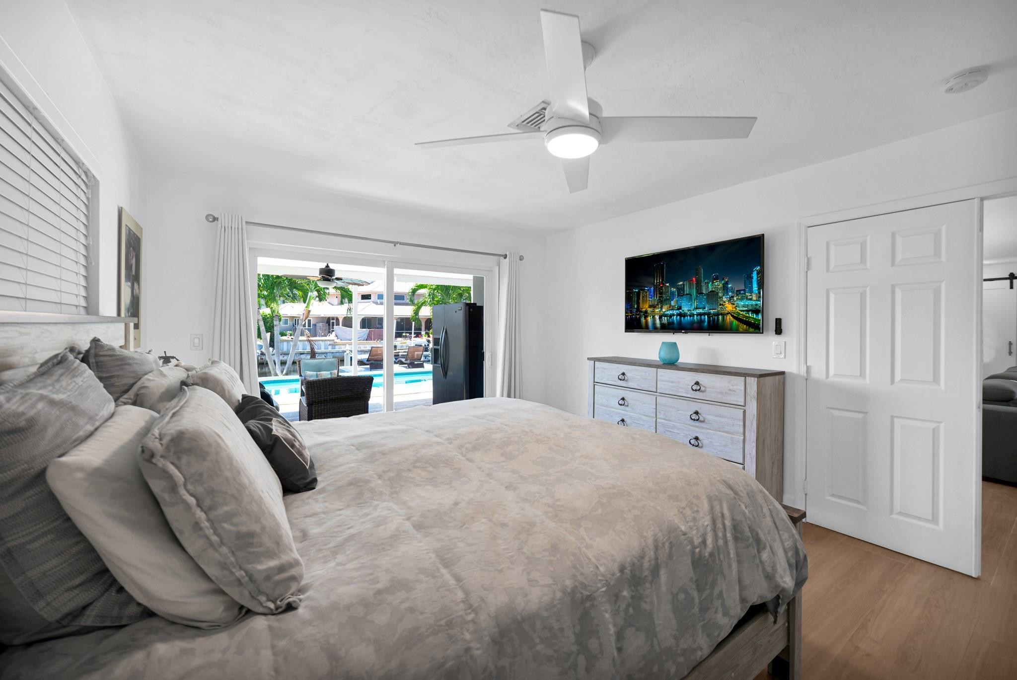 252 Southwest 14th Place Boca Raton, FL 33432 - Photo 18 of 49 a bedroom with a bed and a flat screen tv