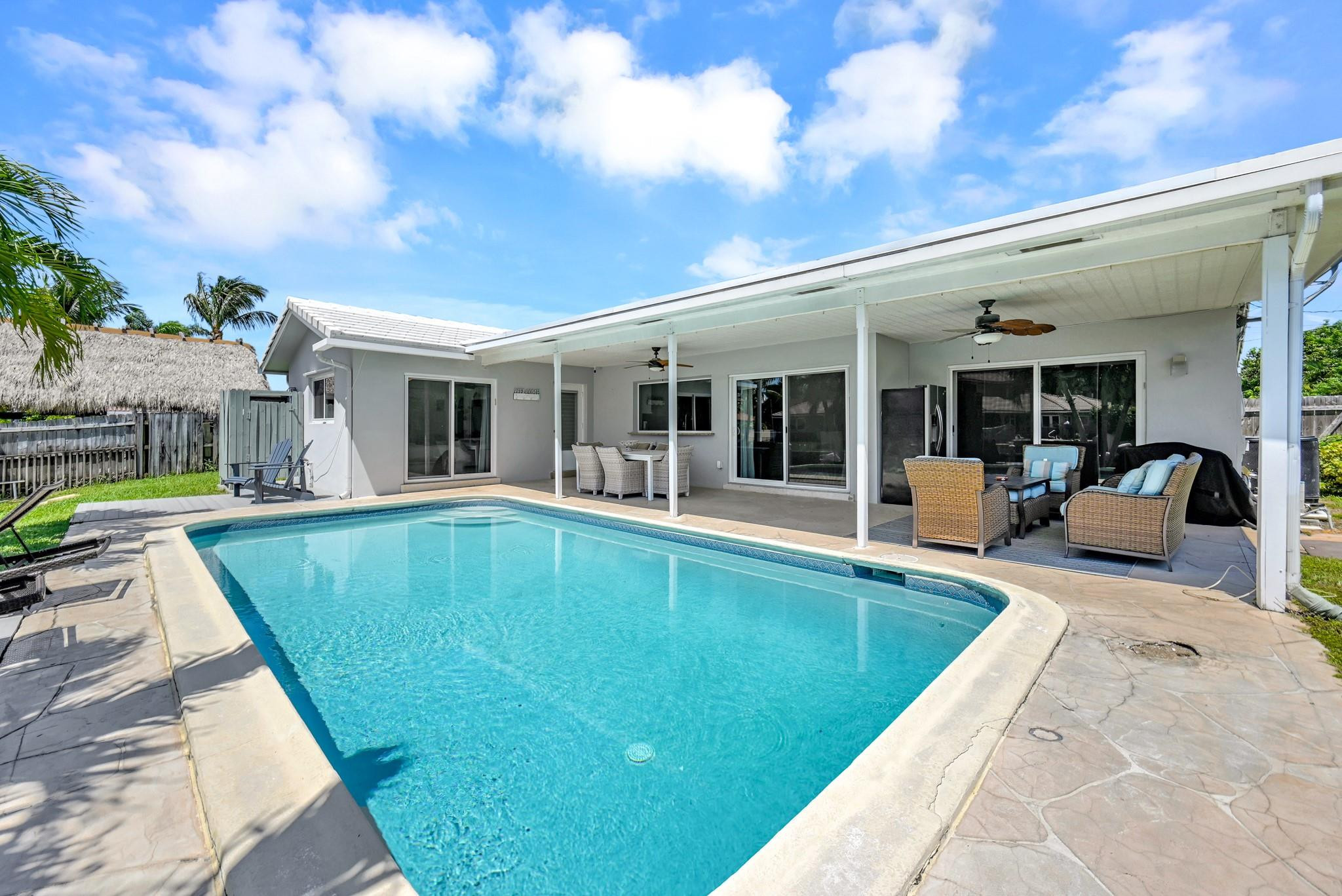 252 Southwest 14th Place Boca Raton, FL 33432 - Photo 31 of 49 a view of a house with swimming pool and sitting area