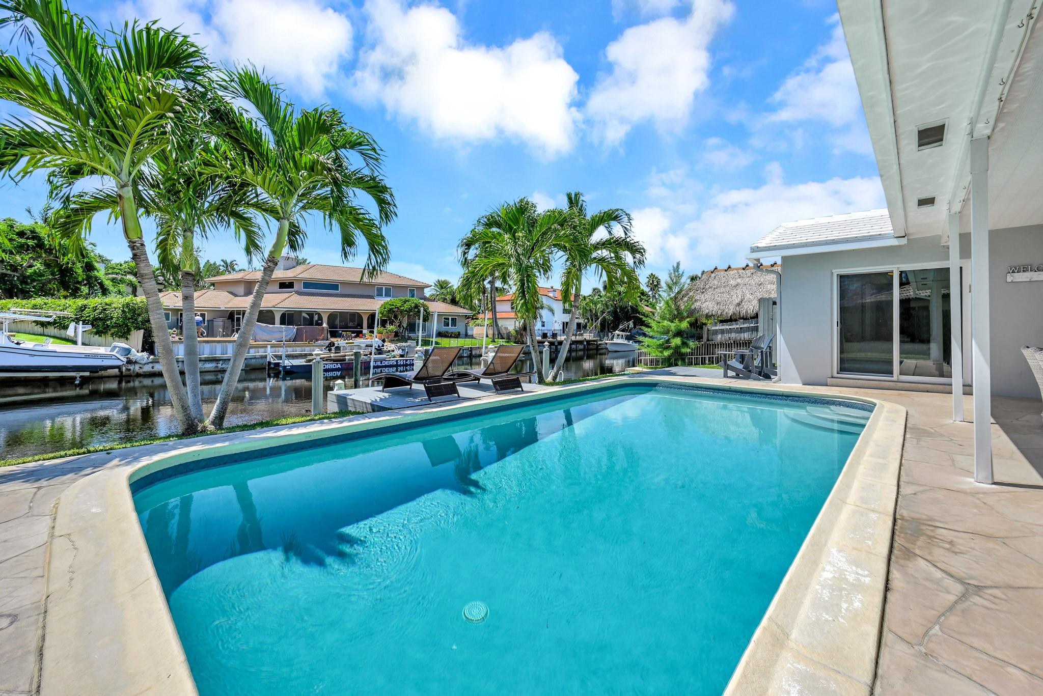 252 Southwest 14th Place Boca Raton, FL 33432 - Photo 33 of 49 a swimming pool with outdoor seating and yard