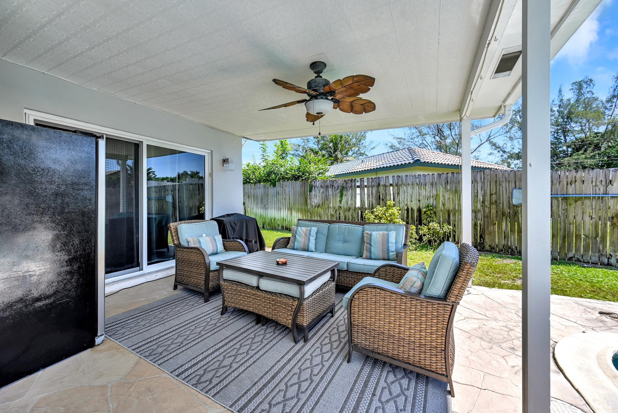 252 Southwest 14th Place Boca Raton, FL 33432 - Photo 35 of 49 a view of a patio with a dining table and chairs