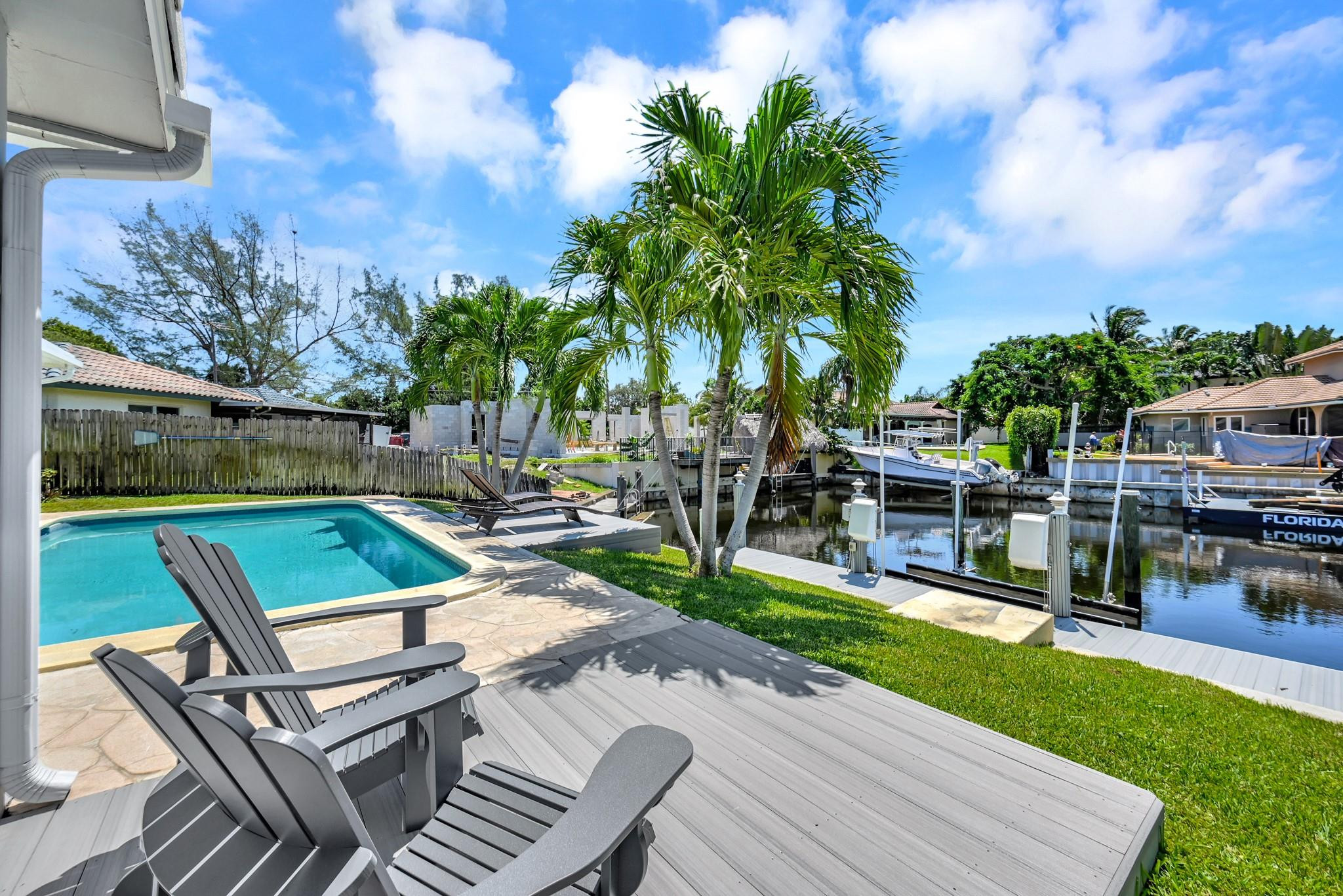 252 Southwest 14th Place Boca Raton, FL 33432 - Photo 36 of 49 a view of a swimming pool with chairs and a yard