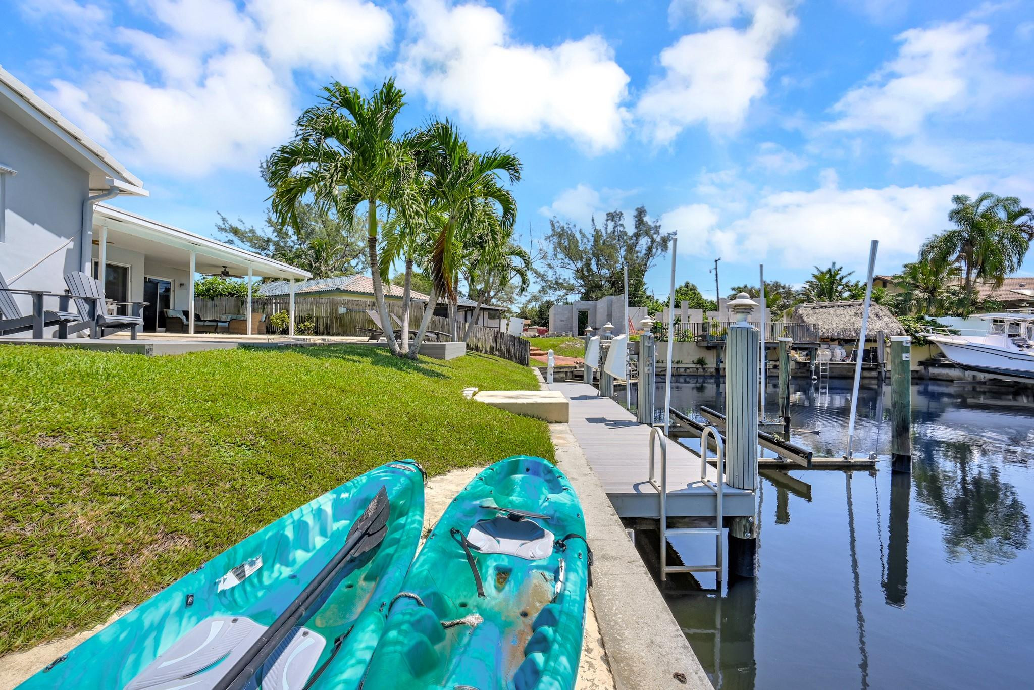 252 Southwest 14th Place Boca Raton, FL 33432 - Photo 37 of 49 a view of a swimming pool with a garden and plants