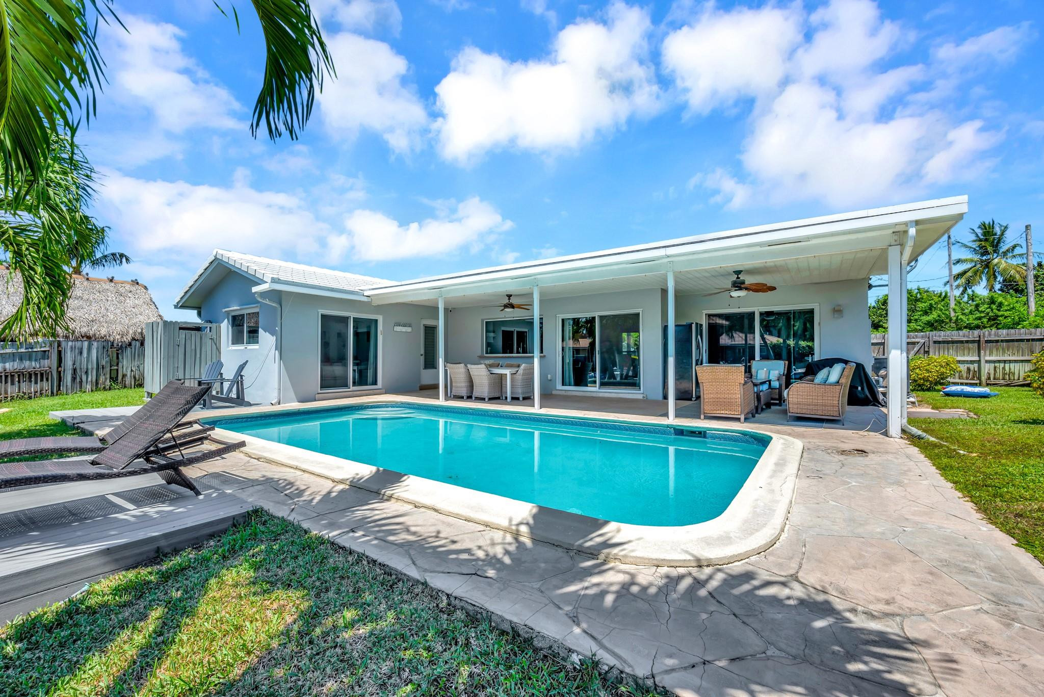 252 Southwest 14th Place Boca Raton, FL 33432 - Photo 7 of 49 a view of a house with backyard sitting area and swimming pool