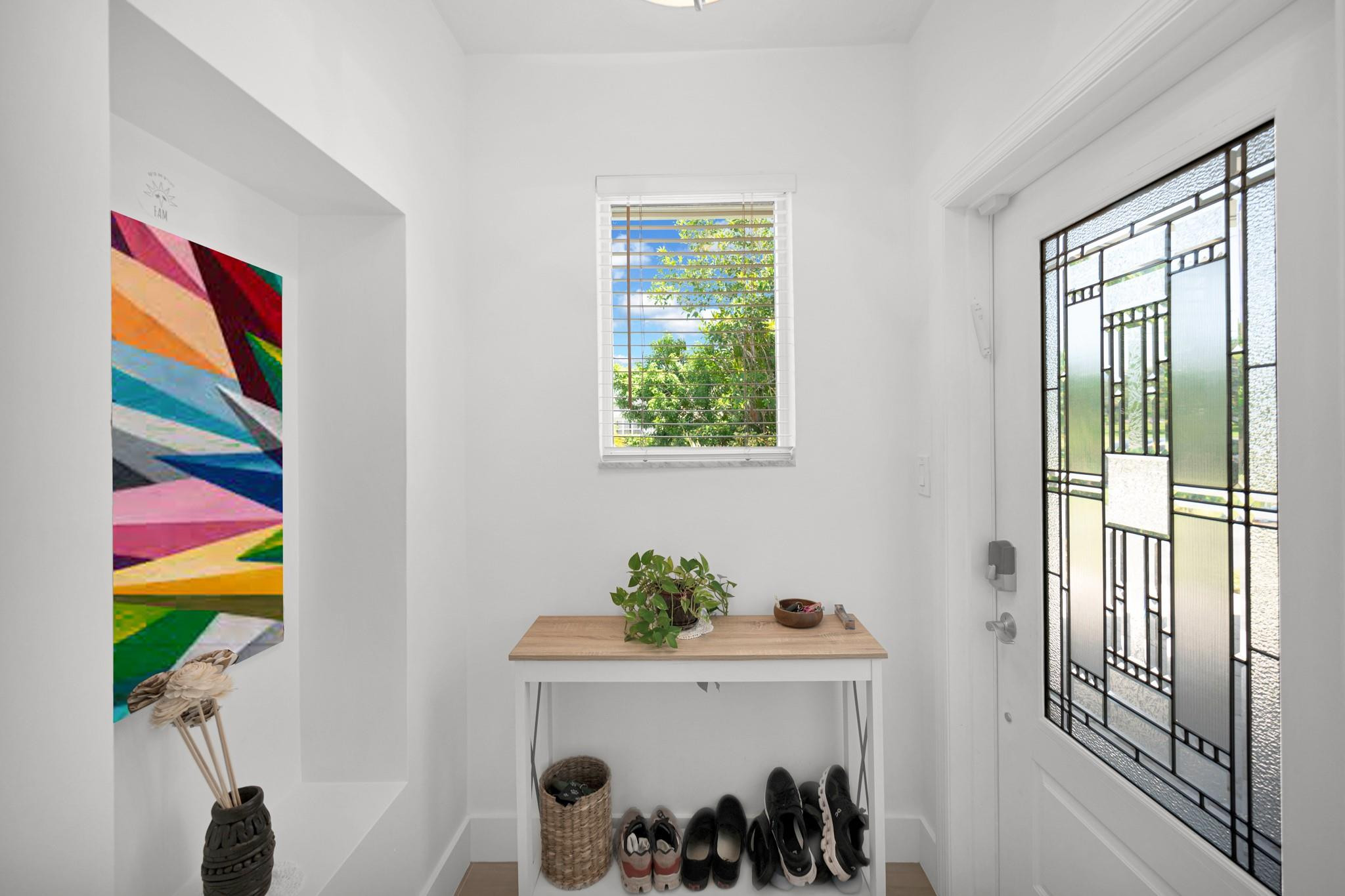 252 Southwest 14th Place Boca Raton, FL 33432 - Photo 8 of 49 a view of a hallway with paintings on the wall