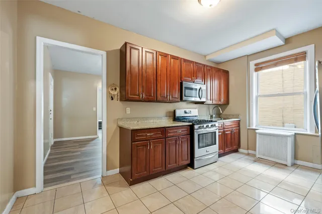 a kitchen with stainless steel appliances granite countertop a stove and a sink