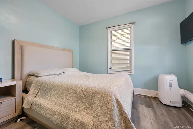 a bedroom with a bed and flat screen tv