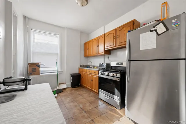 a kitchen with stainless steel appliances granite countertop a refrigerator and a stove