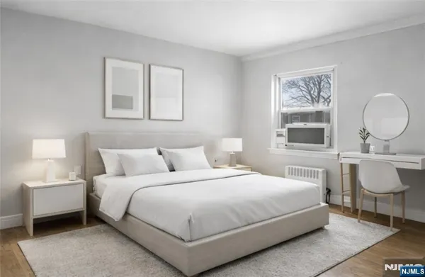 a bedroom with a bed a mirror and a lamp