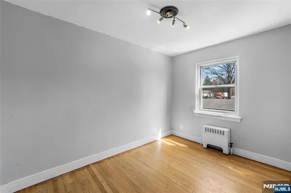 a view of a room with wooden floor and window