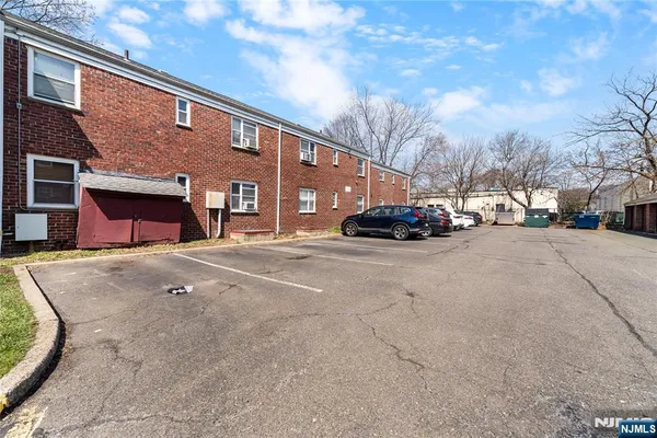 a couple of cars parked in front of brick building