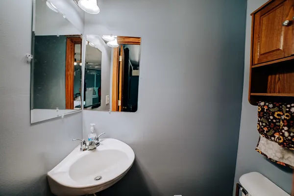 a bathroom with a sink toilet and mirror