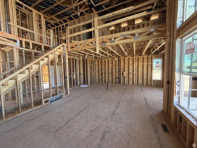 17 South Carson Way Salem, UT 84653 - Photo 4 of 14 Expansive open-concept space featuring a staircase, upper-level balcony, and multiple windows allowing for abundant natural light