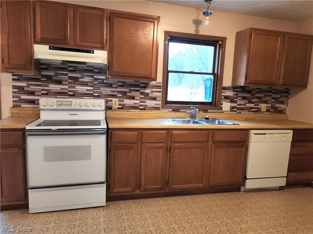 10345 Marne Road Frazeysburg, OH 43822 - Photo 28 of 50 Kitchen featuring sink, white appliances, and tasteful backsplash