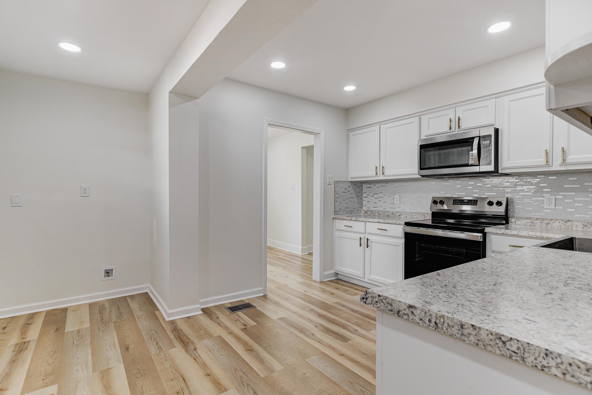 3438 Vanuys Road Memphis, TN 38111 - Photo 13 of 32 a kitchen with stainless steel appliances granite countertop a stove a sink and a microwave
