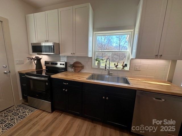 1224 Phillipsville Loop Canton, NC 28716 - Photo 13 of 22 a kitchen with stainless steel appliances granite countertop a sink stove and cabinets