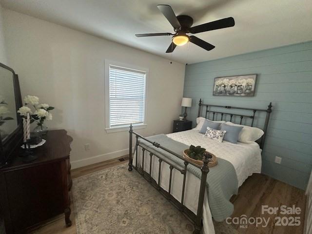 1224 Phillipsville Loop Canton, NC 28716 - Photo 15 of 22 a bedroom with a bed and a chandelier