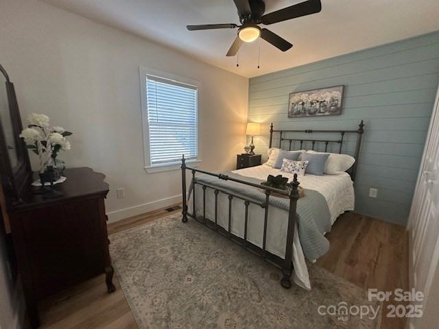 1224 Phillipsville Loop Canton, NC 28716 - Photo 17 of 22 a bedroom with a bed and a chandelier