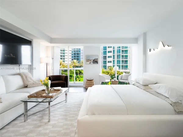 a living room with furniture white walls and lamp