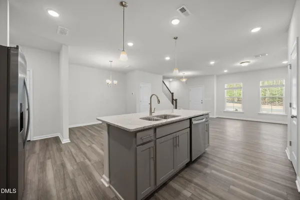 a kitchen with a sink a refrigerator and window