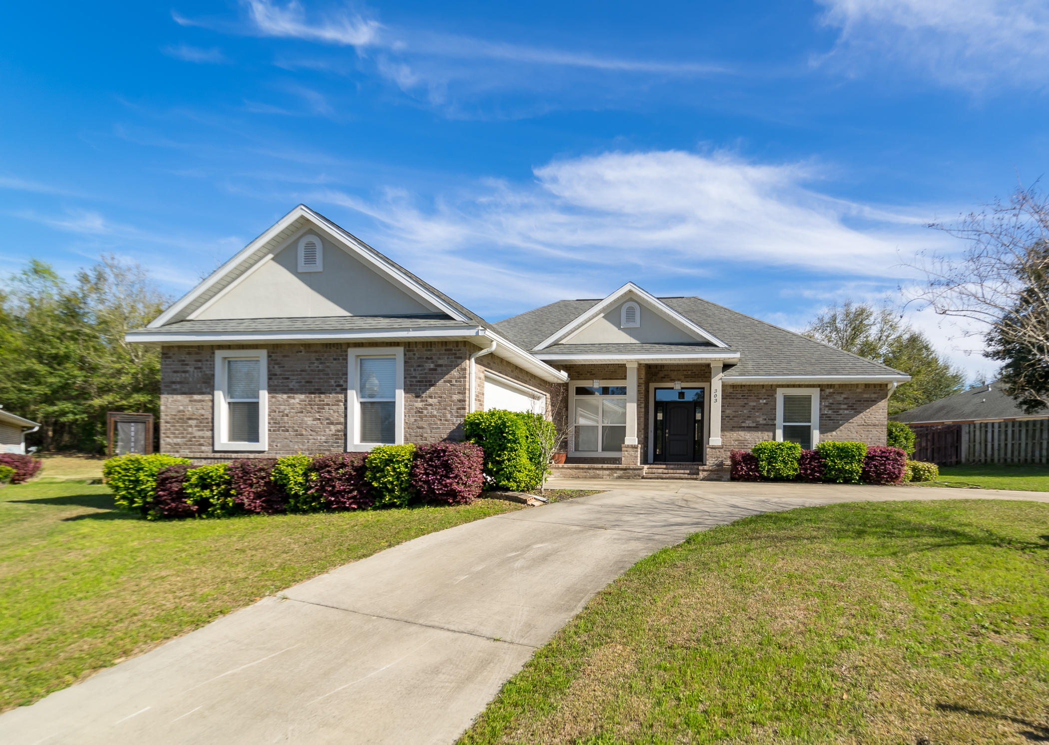 303 Greyfox Circle Crestview, FL 32536 - Photo 1 of 24 a front view of a house with garden
