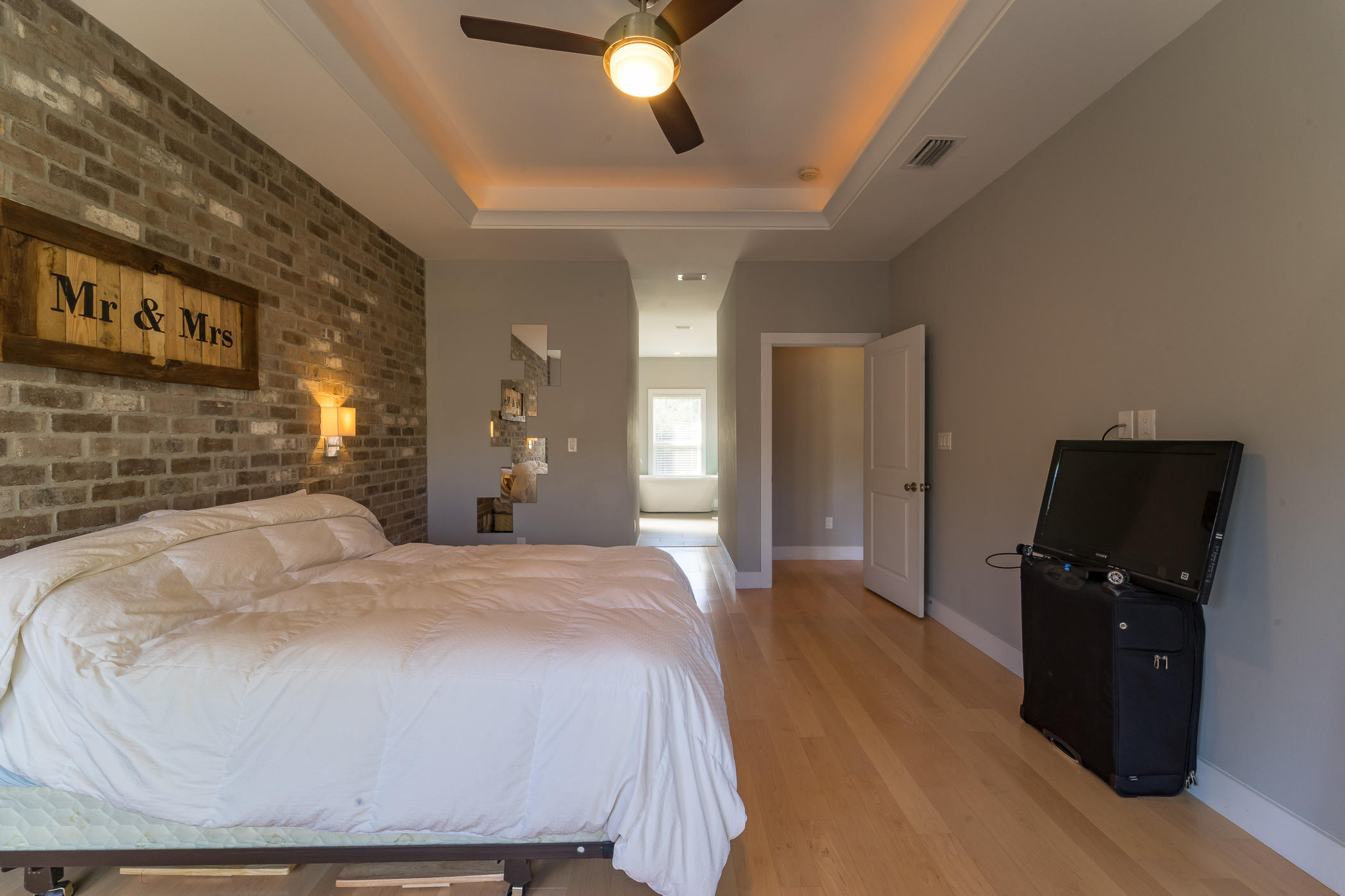 303 Greyfox Circle Crestview, FL 32536 - Photo 13 of 24 a spacious bedroom with a bed and a flat screen tv