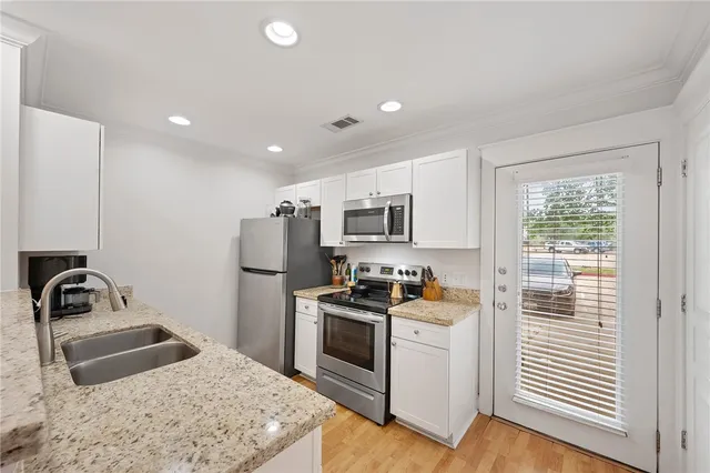 a kitchen with a sink stove and refrigerator
