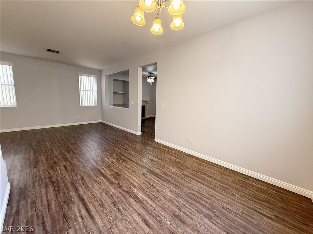2185 Polynesia Circle Henderson, NV 89074 - Photo 7 of 37 Rich hardwood-style flooring extends across this spacious, naturally illuminated room.
