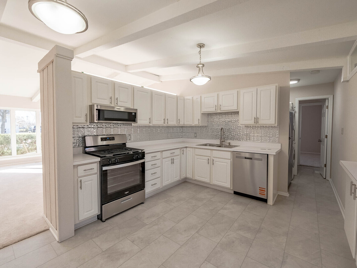 724 Surrey Drive Streamwood, IL 60107 - Photo 3 of 14 a kitchen with stove a sink and white cabinets