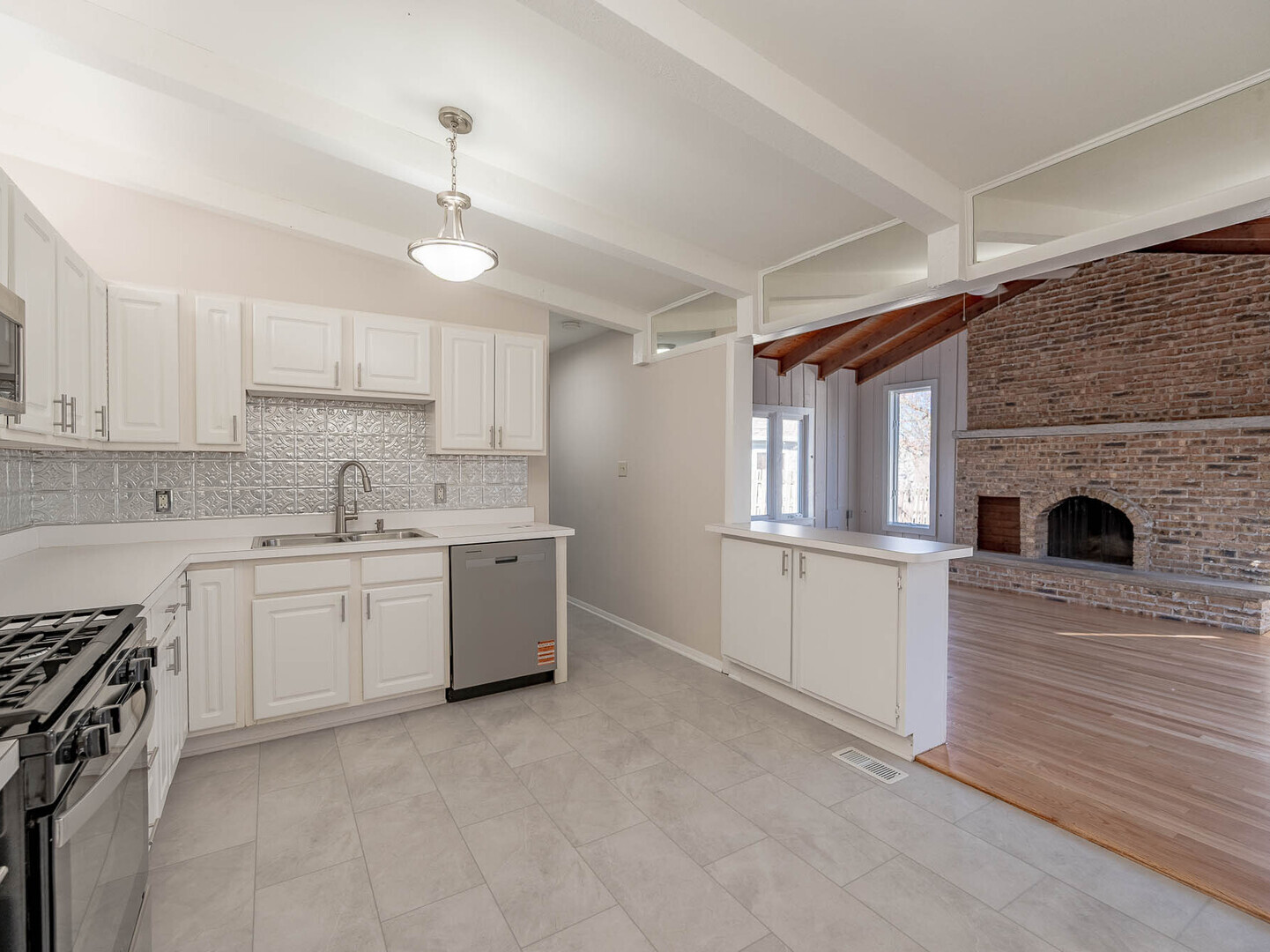 724 Surrey Drive Streamwood, IL 60107 - Photo 4 of 14 a kitchen with a stove top oven and sink