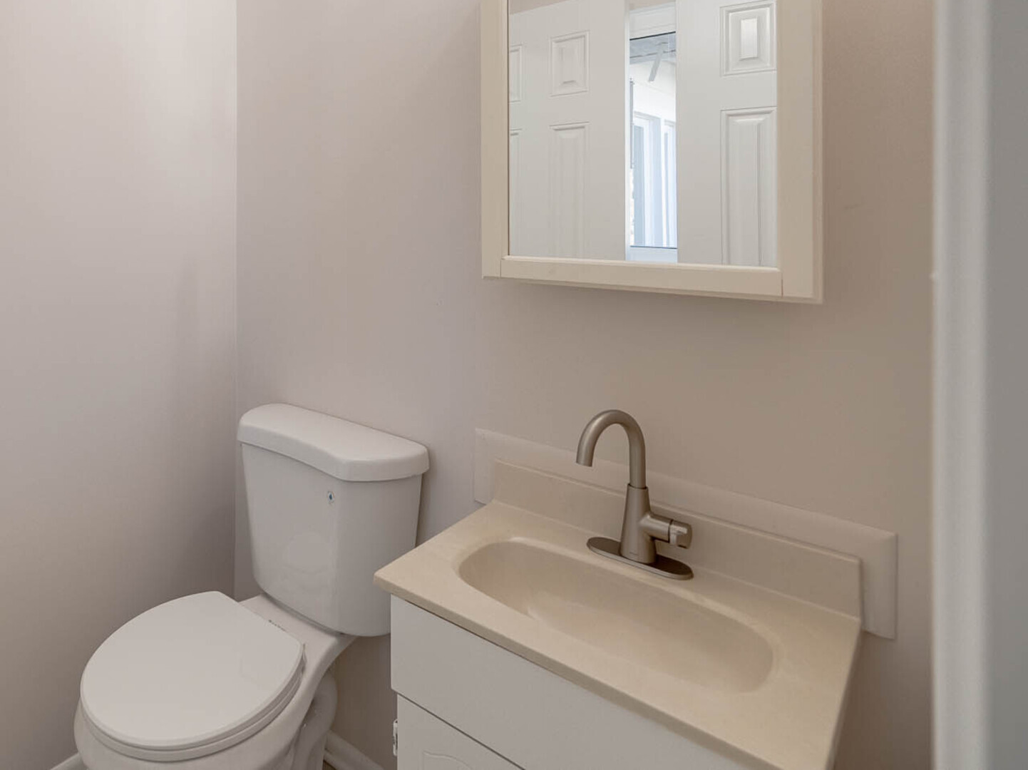 724 Surrey Drive Streamwood, IL 60107 - Photo 7 of 14 a bathroom with a toilet sink and mirror