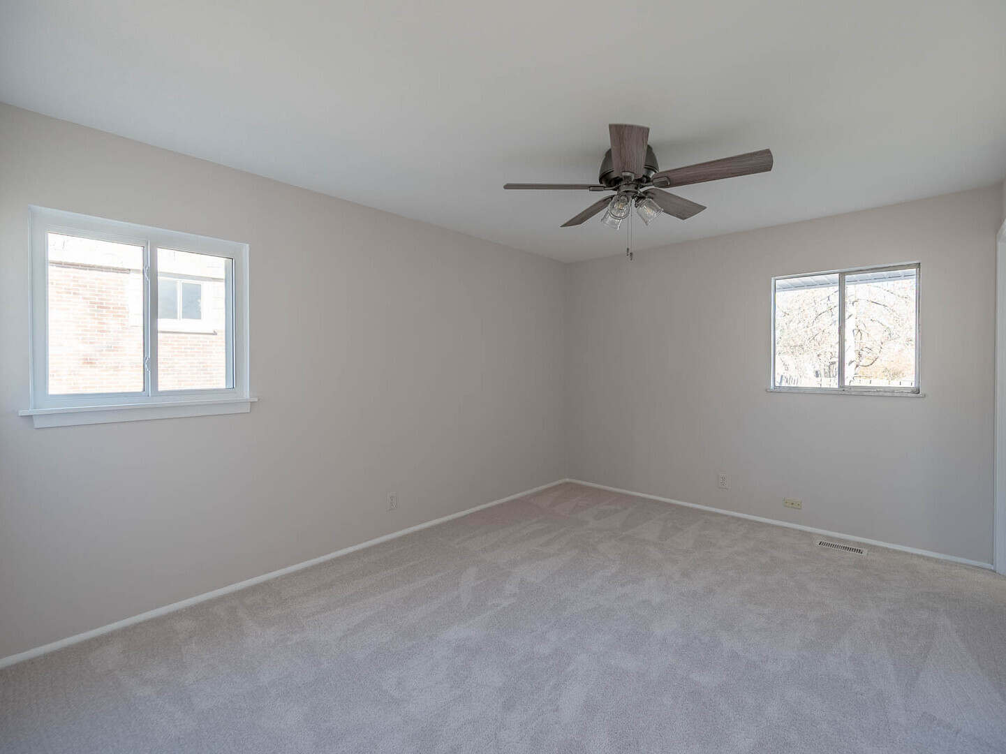 724 Surrey Drive Streamwood, IL 60107 - Photo 10 of 14 an empty room with windows and fan