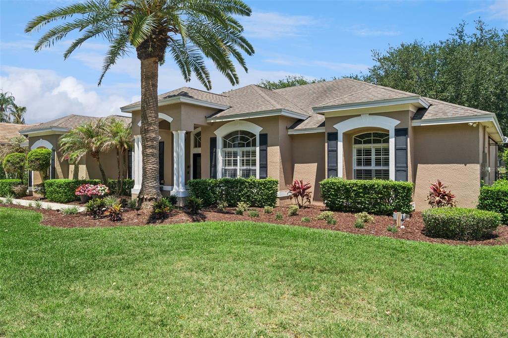 2230 Ridgewind Way Windermere, FL 34786 - Photo 2 of 38 a front view of a house with a garden and patio