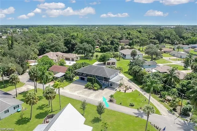 an aerial view of a house with a garden and lake view