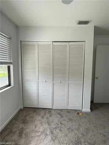 an empty room with closet area