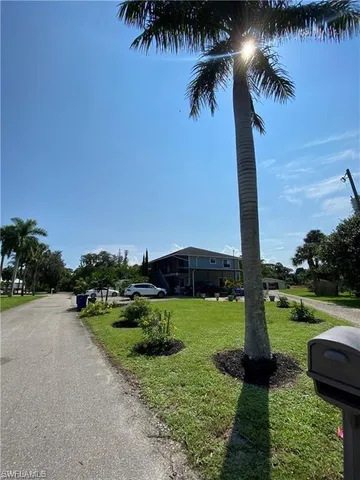 an ocean view with beach and palm trees