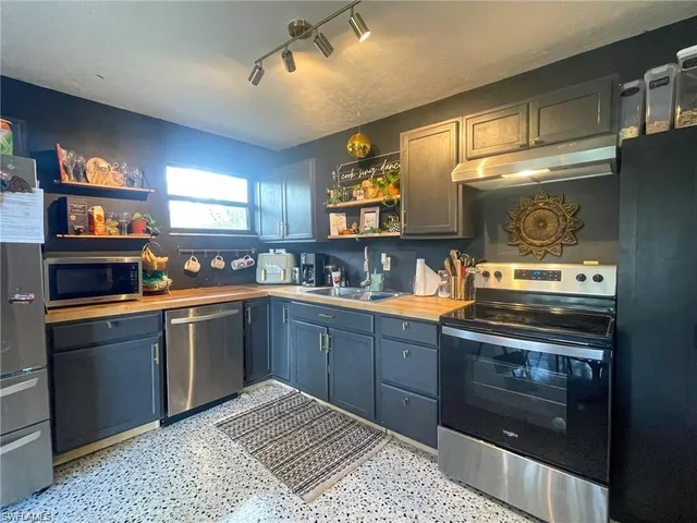 a kitchen with stainless steel appliances granite countertop a stove and a sink