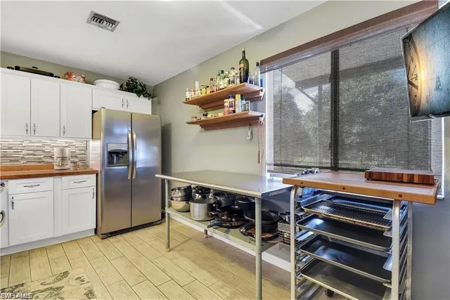 a kitchen with stainless steel appliances a refrigerator and cabinets