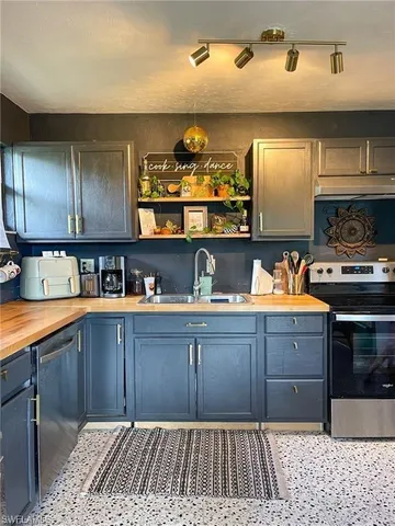 a kitchen with stainless steel appliances granite countertop a sink and cabinets