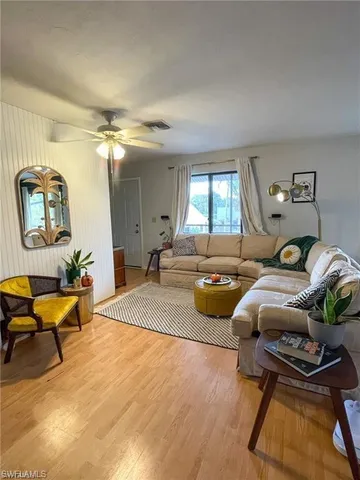 a bedroom with furniture and wooden floor