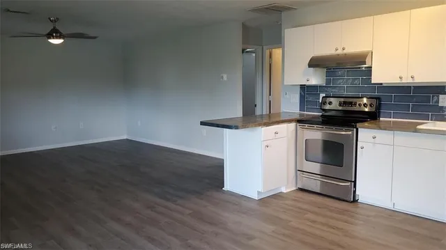 a kitchen with granite countertop a stove and a fireplace