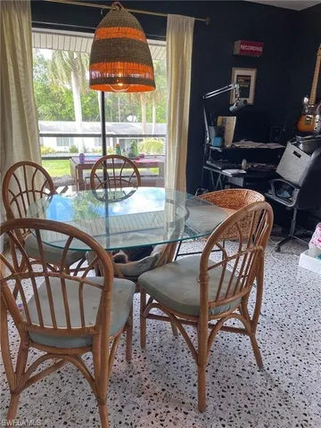 a dining room with furniture and window